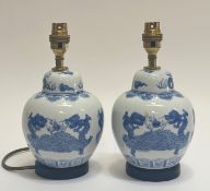 A pair of blue and white ginger jar style table lamps decorated with a dragon scene (h- 25cm)