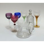 A mixed group comprising a decanter (h-22cm), a crystal jug, two long coloured stemmed flower headed