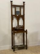 An early 20th century oak mirror back hall stand, fitted with four hooks and a glove box, (lacking