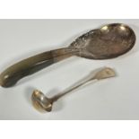 A Eastern white metal serving spoon with pierced dragon and engraved lotus flower design and