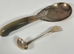 A Eastern white metal serving spoon with pierced dragon and engraved lotus flower design and