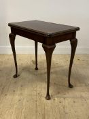 An early 20th century figured walnut card table, the fold over revolving top raised on cabriole
