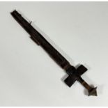 An African tuarey short sword and scabbard, steel pommel, leather covered hilt and handle, steel