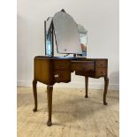 An early 20th century walnut dressing table, with triptych mirror over one long and four short