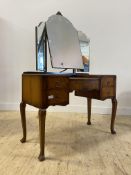 An early 20th century walnut dressing table, with triptych mirror over one long and four short