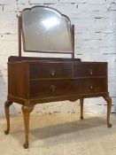 An early 20th century mahogany dressing chest, with swing mirror over two short and one long drawer,