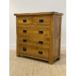 An oak chest fitted with two short and three long drawers, raised on stile supports H98cm, W98cm,