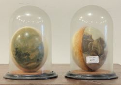A pair of Victorian touristware ostrich eggs, one painted with landscape, the other with lion,