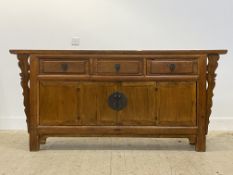 A Chinese hardwood sideboard, fitted with three drawers over bi-fold cupboards, raised on stile