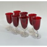 A set of seven ruby red tulip shaped wine glasses (two small chips to rim) (h- 16cm) (7)