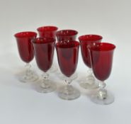A set of seven ruby red tulip shaped wine glasses (two small chips to rim) (h- 16cm) (7)