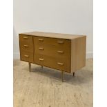 Stag, a mid century light oak veneered chest, fitted with three short flanked by three long drawers,