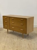 Stag, a mid century light oak veneered chest, fitted with three short flanked by three long drawers,