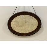 An early 20th century scumbled composition oval wall hanging mirror 59cm x 74cm