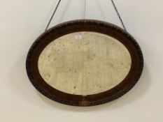 An early 20th century scumbled composition oval wall hanging mirror 59cm x 74cm