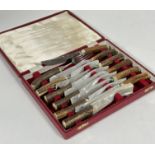 A set of six pairs of John B Chatterley & Sons of Sheffield horn handled steak knives and forks, L