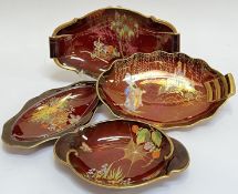 A group of Carlton Ware Rouge Royale comprising four oval dishes variously decorated in gilt and