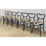 A set of seven Victorian ebonised dining chairs, with open kidney backs over upholstered seats and