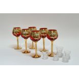 A set of six gilt red wine glasses with enameled floral decoration on twist stem (h-18cm) and four