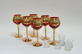 A set of six gilt red wine glasses with enameled floral decoration on twist stem (h-18cm) and four