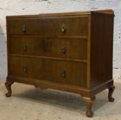 An early 20th century mahogany chest, with ledge back over three graduated drawers, raised on