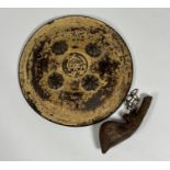 An Eastern leather shield with four conical brass bosses, leather handles to rear, dia.35cm and a