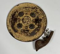 An Eastern leather shield with four conical brass bosses, leather handles to rear, dia.35cm and a