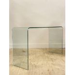 A contemporary line bent glass console table H70cm, W124cm, D40cm