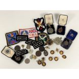 A mixed lot of shooting medals, buttons etc. (a lot)