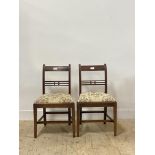 A pair of George III mahogany side chairs, each with rail back over drop in upholstered seat pads,