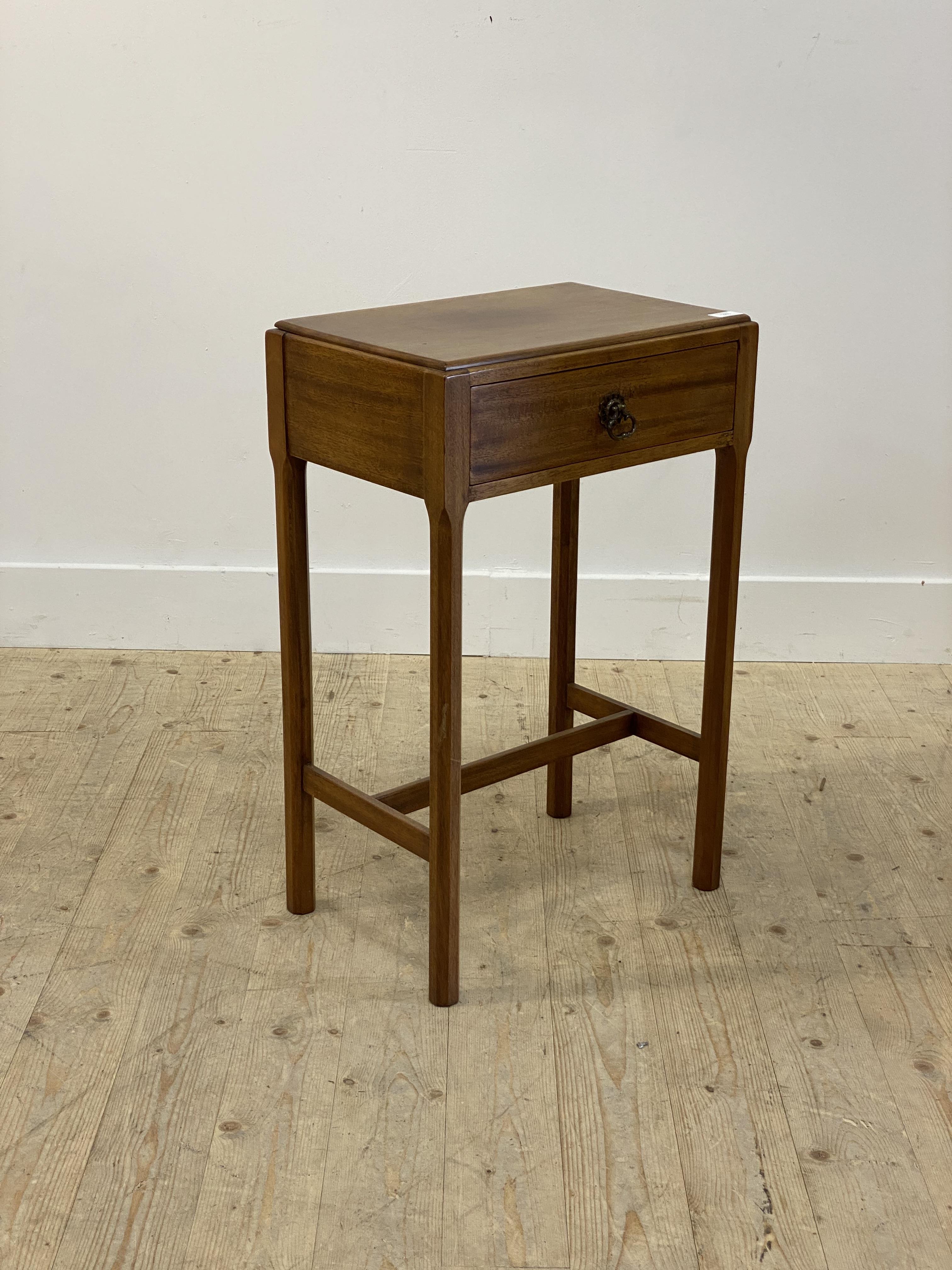A Georgian style mahogany side table, with single frieze drawer raised on faceted supports united by