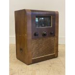 A 1930's Art Deco period walnut veneered wireless valve radio, complete with four old tube valves