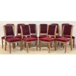 A set of ten Victorian oak dining chairs, with carved and moulded show frame enclosing red velvet