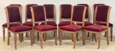 A set of ten Victorian oak dining chairs, with carved and moulded show frame enclosing red velvet