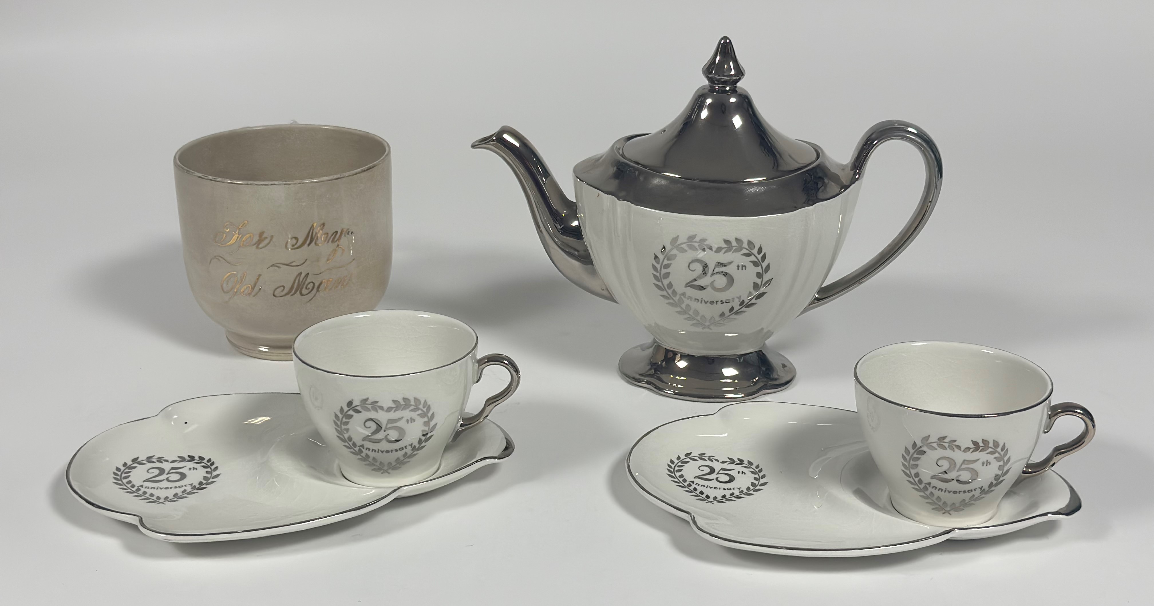 A Royal Winton Grimwades 25th Anniversary silver tea pot (h-21cm), two cups and two saucers with