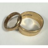 A 9ct gold plain wedding band, L and a 9ct gold gents engine turned engraved wedding band, X. 8.5g