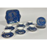 A Wedgwood Blue Dragon Lustre part tea service comprising six tea cups, a serving dish (w-27cm), six