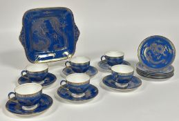 A Wedgwood Blue Dragon Lustre part tea service comprising six tea cups, a serving dish (w-27cm), six