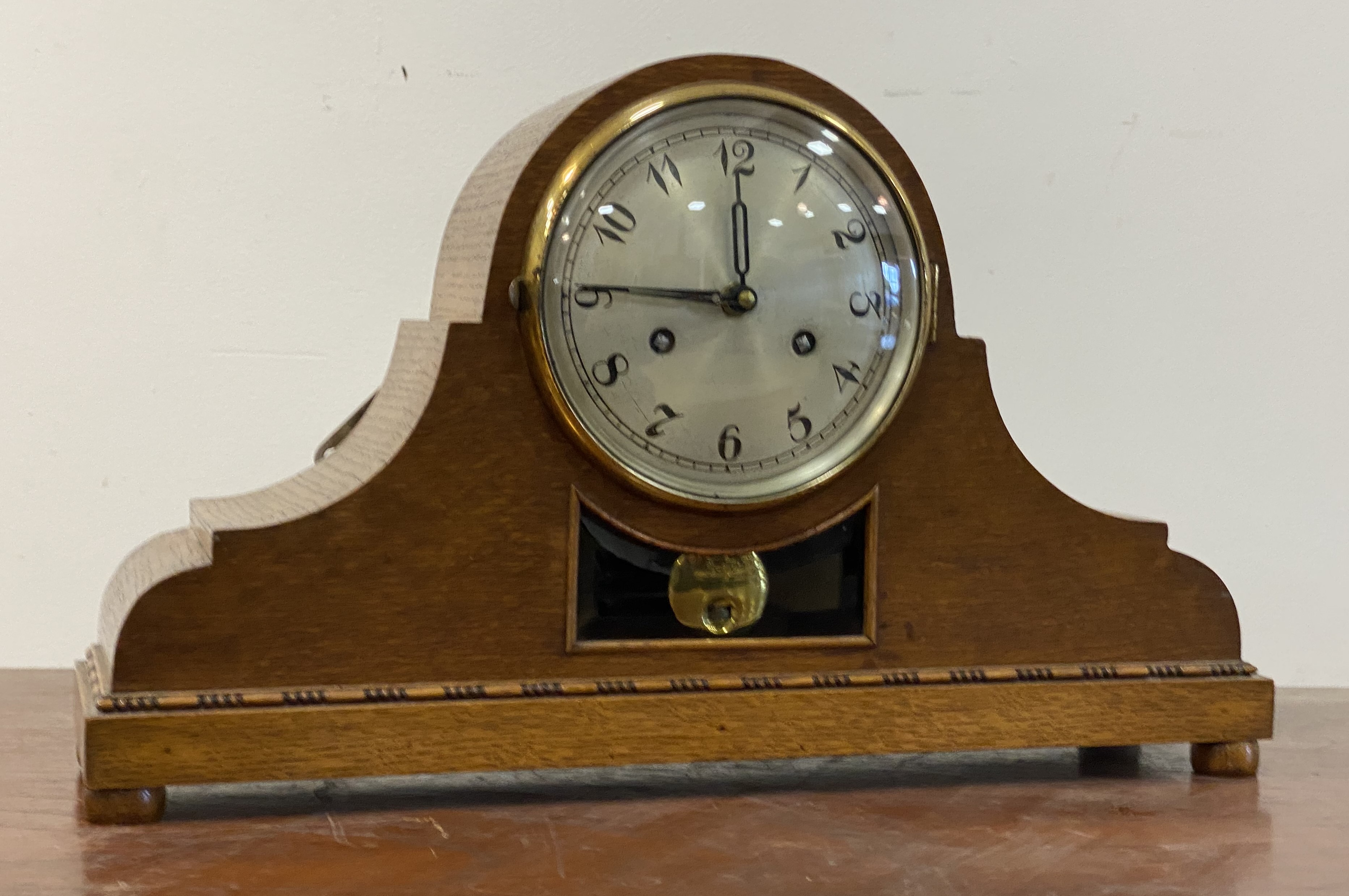 An early 20th century oak cased mantel clock, the silvered dial with Arabic chapter ring, later