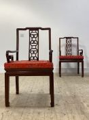 A pair of Chinese Ming style hardwood chairs, with pierce carved splat back over scrolled open