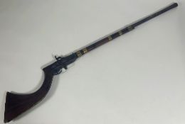 A 19thc Jezail percussion rifle, wooden stock, hexagonal barrel with brass and steel fittings (125.