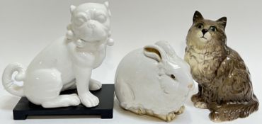 A group of ceramic ornamental animals comprising a Beswick cat (h- 21cm), a white glazed rabbit (