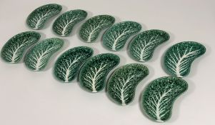 A set of twelve ceramic Portuguese green cabbage leaf side dishes (l- 22cm w-12cm) (marked verso -