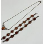 A silver link bracelet set seven oval amber cabochons in open scroll mounts, L 19cm, a simialr