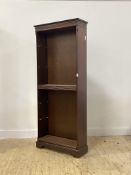 A Georgian style mahogany open bookcase, with dentil cornice over five shelves, raised on bracket