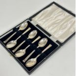 A set of six Sheffield silver Art Deco style tea spoons with scroll terminals complete with fitted