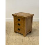 An oak bedside chest fitted with three drawers, stile supports H60cm, W51cm, D41cm