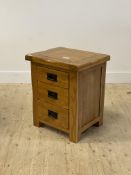An oak bedside chest fitted with three drawers, stile supports H60cm, W51cm, D41cm