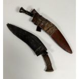 Two early 20thc. Nepalese kukris, one with horn handle, missing, one small knife in leather scabbard