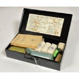 A WWII Air Raid Precautions First Aid Kit by Boots, black metal tin containing pressing bandages,